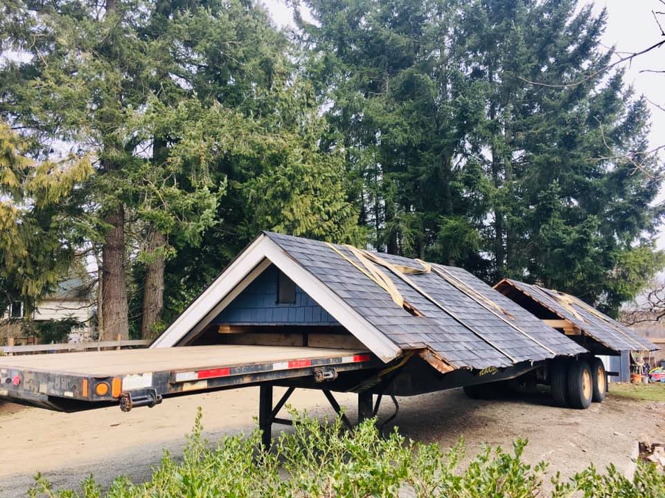 Roof sections to be moved separately after house has been moved. The roof of the Blueberry Cottage is loaded on a trailer.