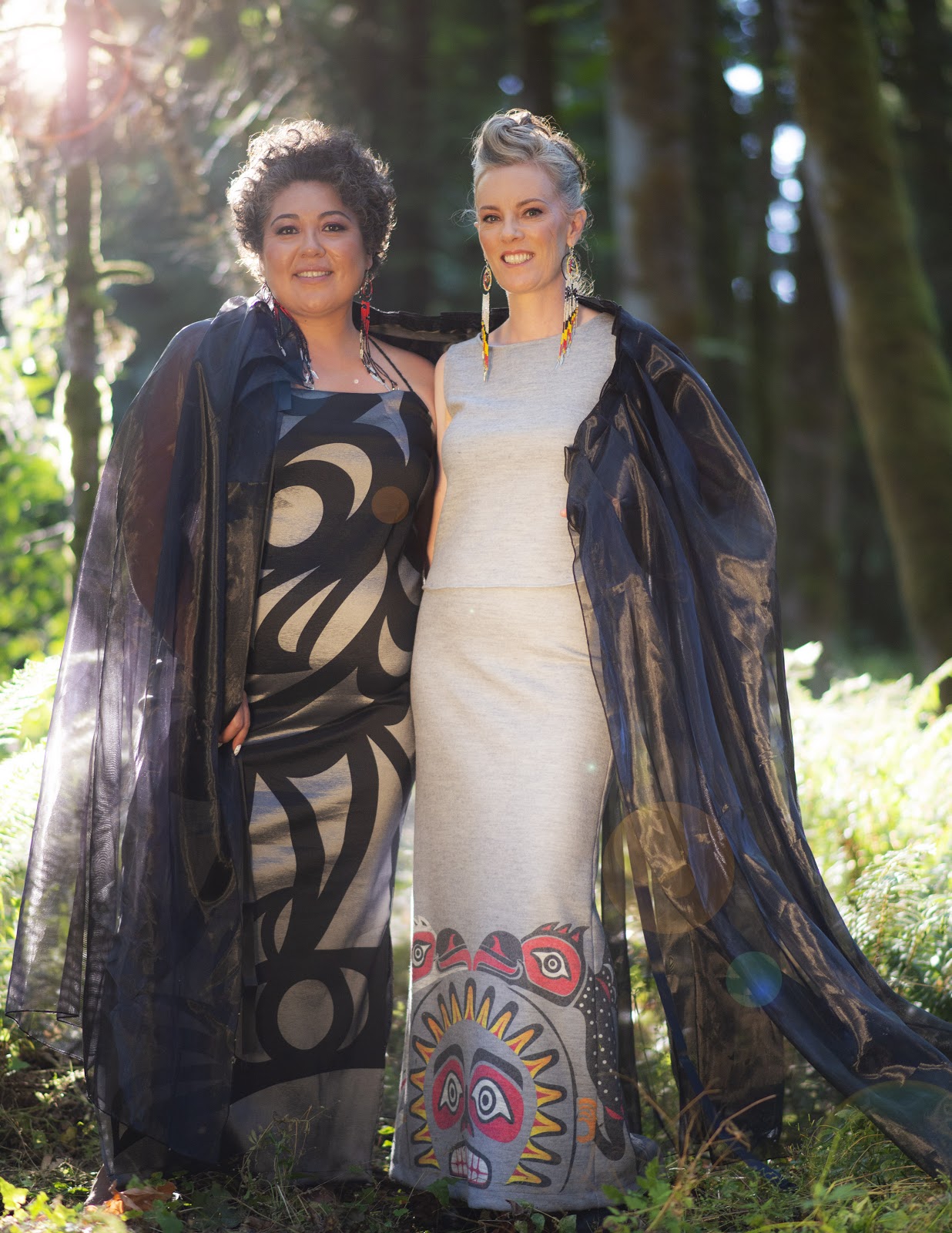 Sisters Sophia Seward Good (left) and Aunalee Boyd-Good wear dresses from their Fall/winter 2020 collection in the sun kissed forest.