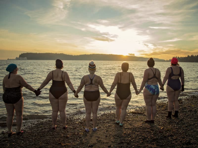 Cold water swimmers join hands before they brave the plunge at Departure Bay on Jan. 9.