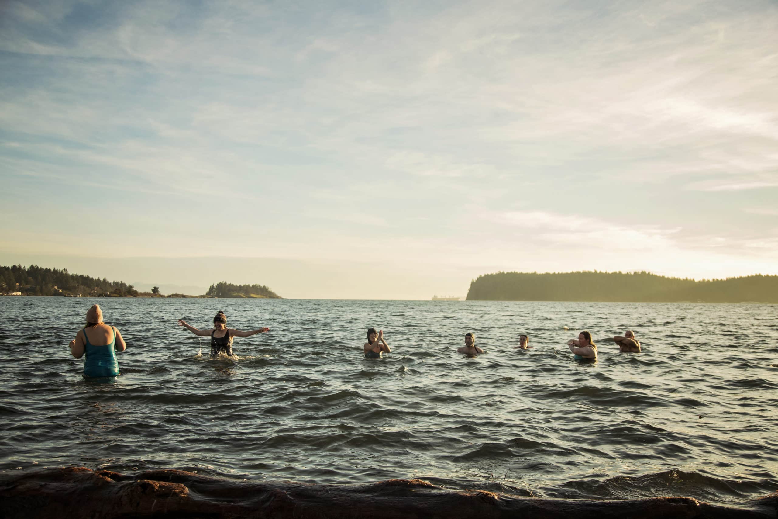 In Departure Bay, a group of locals keep their hands above water as they splash around and practice cold water swimming.