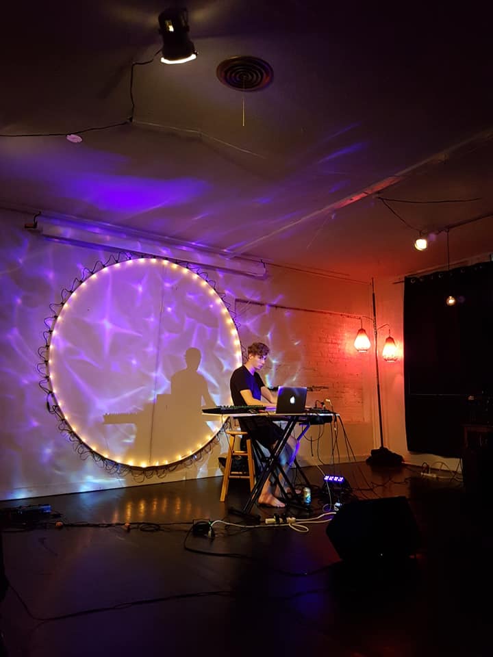 Nanaimo performing artist Liam Ross Gibson performs a solo experimental set in 2018 at the White Room with glowing lights on stage