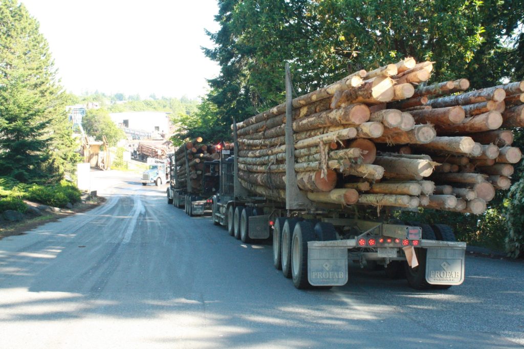 A truck transfers logs near the Coastland Mill in Nanaimo, B.C.