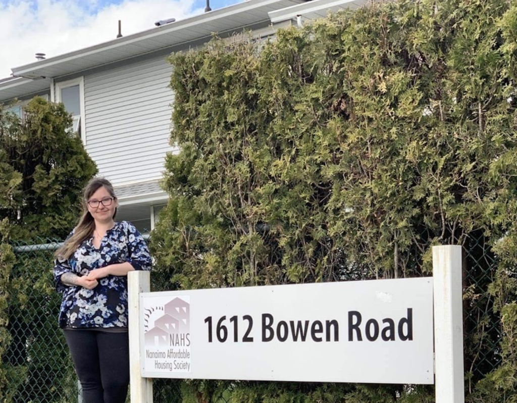 A parent at the Quarterway family housing complex stands by the address sign on Bowen Road in Nanaimo.