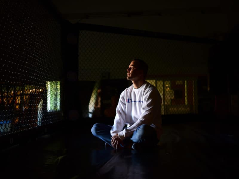 Shane Jung sits in the ring at Black Box MMA