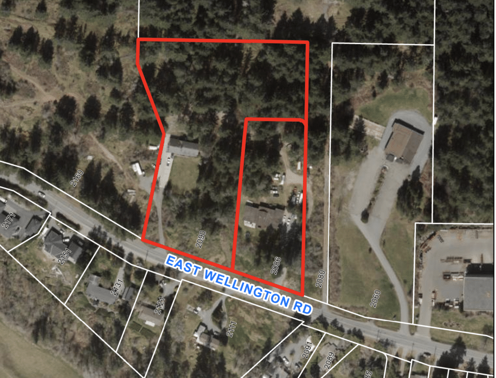 An aerial photo shows the two lots on East Wellington Road up for rezoning, shown in red outline.