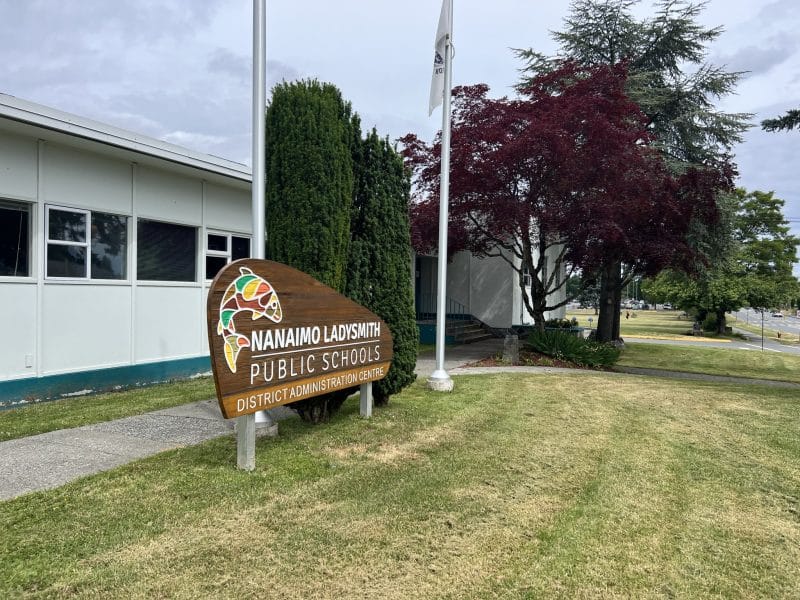 An image of the Nanaimo Ladysmith Public Schools district office, with a sign out front.