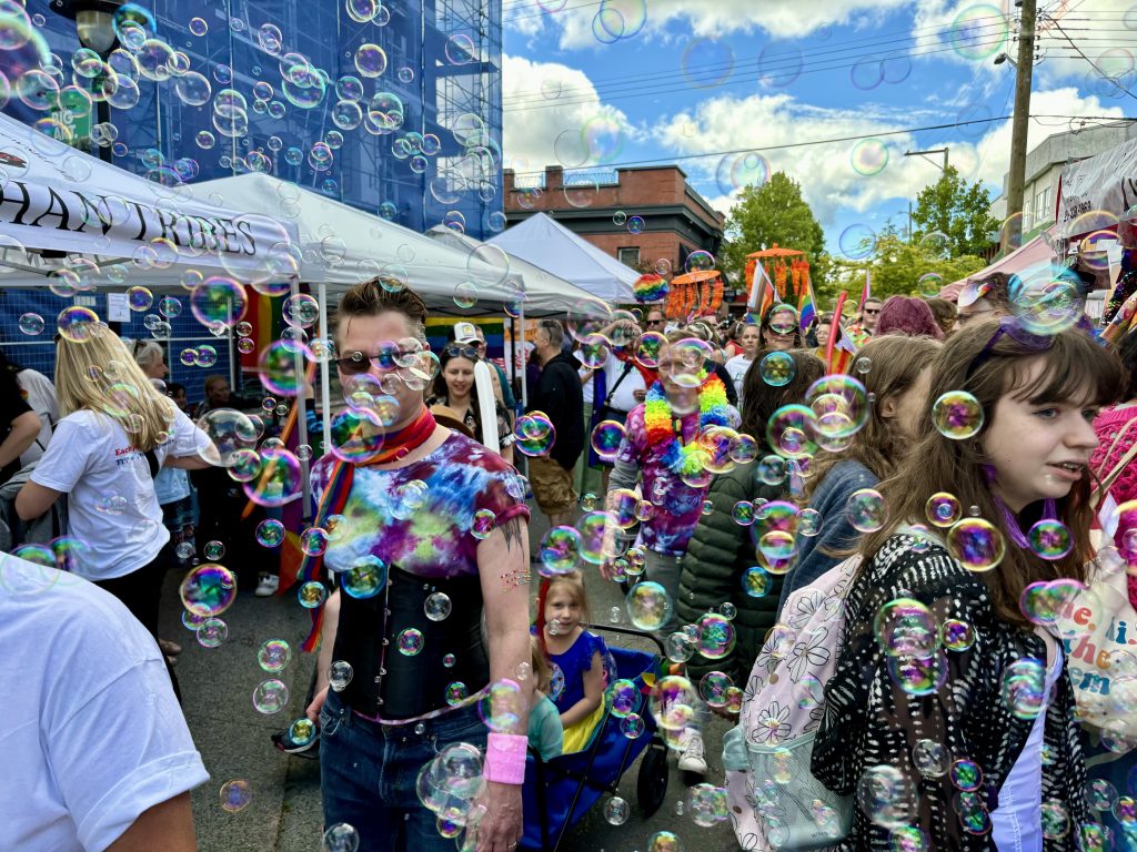 Bubbles catch the sun and float amongst a crowd of people in downtown Duncan.